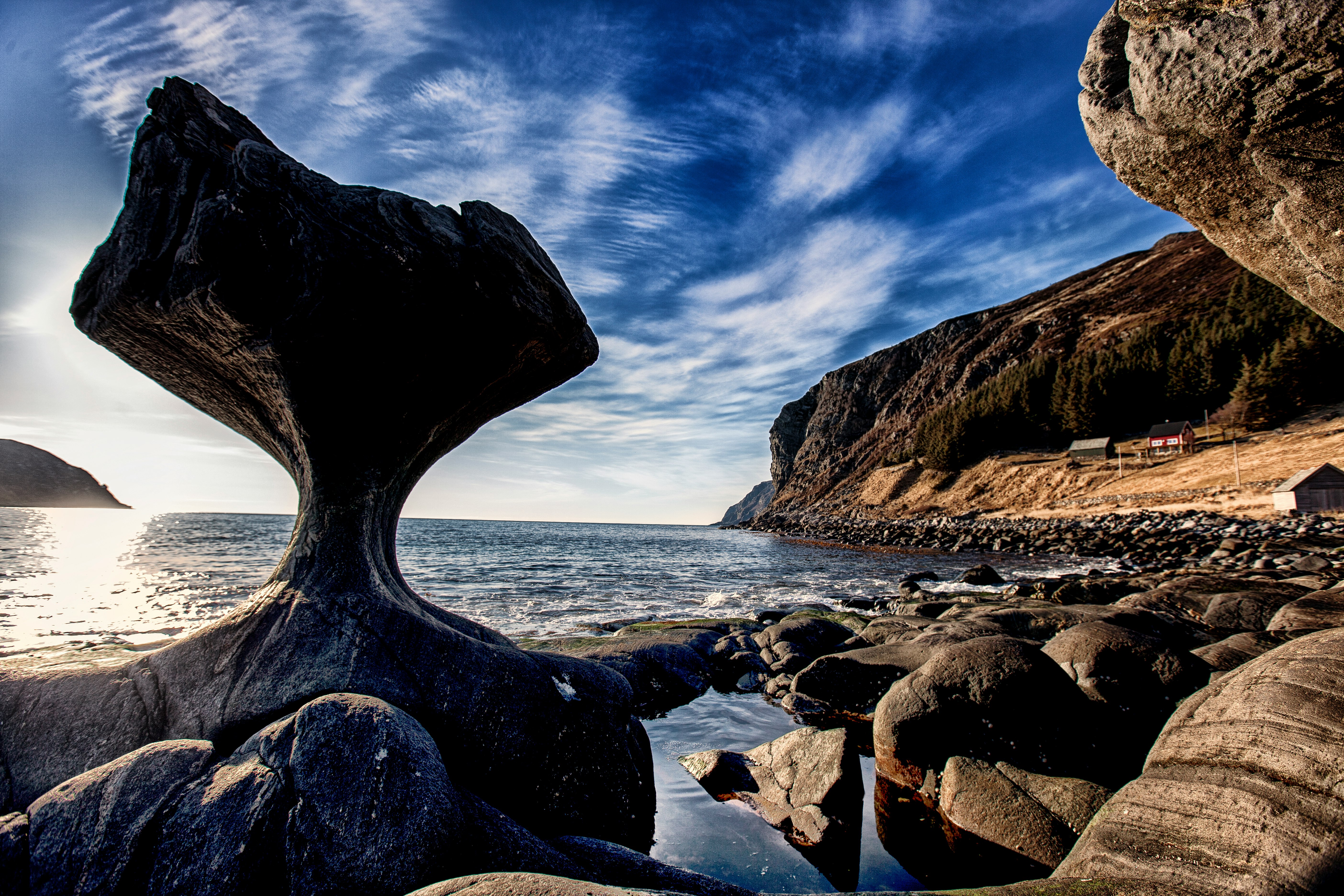 brown rock formation beside beach